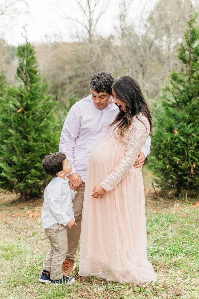 Heartwarming candid moments from a tree farm family session in Georgia, capturing laughter and love in a rustic outdoor setting