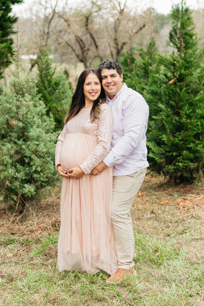 Heartwarming candid moments from a tree farm family session in Georgia, capturing laughter and love in a rustic outdoor setting