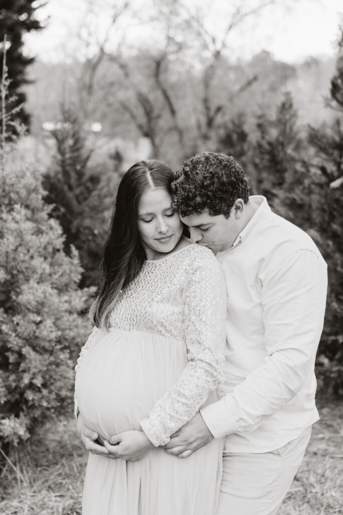 Heartwarming candid moments from a tree farm family session in Georgia, capturing laughter and love in a rustic outdoor setting