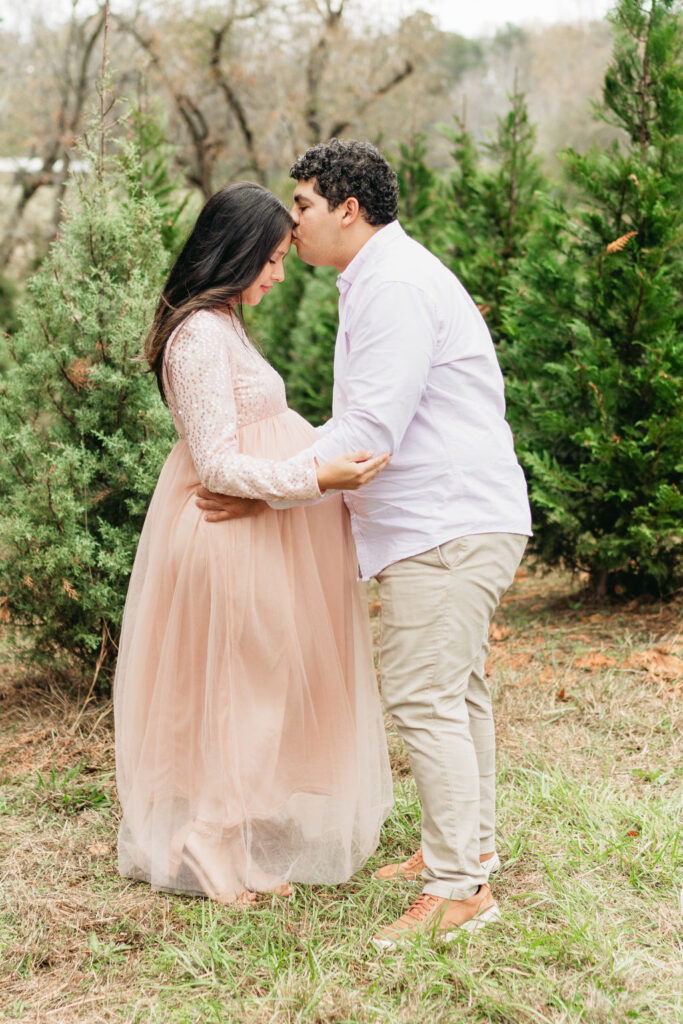 Heartwarming candid moments from a tree farm family session in Georgia, capturing laughter and love in a rustic outdoor setting