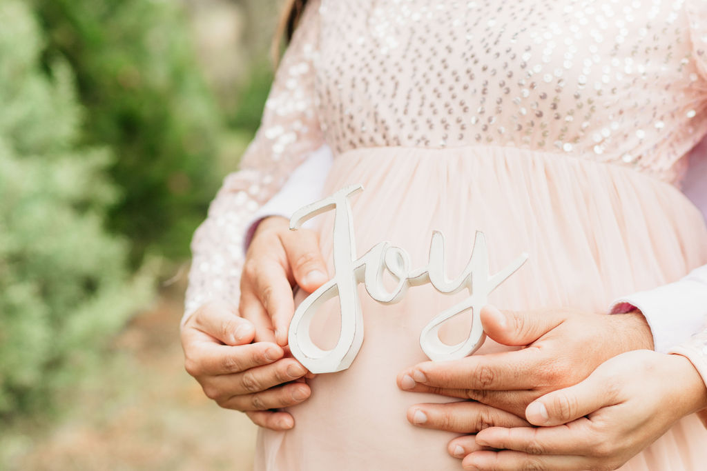 A cozy tree farm family photography session in Georgia, featuring a family posing among lush evergreens during golden hour.