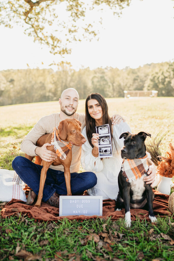 Caitlin and Kyle’s fall maternity session at a park in Flowery Branch, Georgia, featuring autumn foliage and a maternity picnic setup