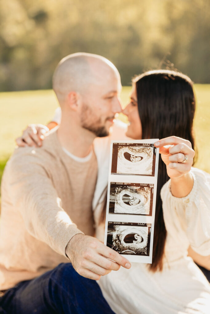 Caitlin and Kyle’s fall maternity session at a park in Flowery Branch, Georgia, featuring autumn foliage and a maternity picnic setup