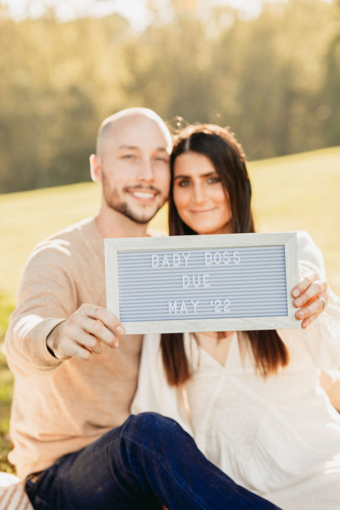 Caitlin and Kyle’s fall maternity session at a park in Flowery Branch, Georgia, featuring autumn foliage and a maternity picnic setup