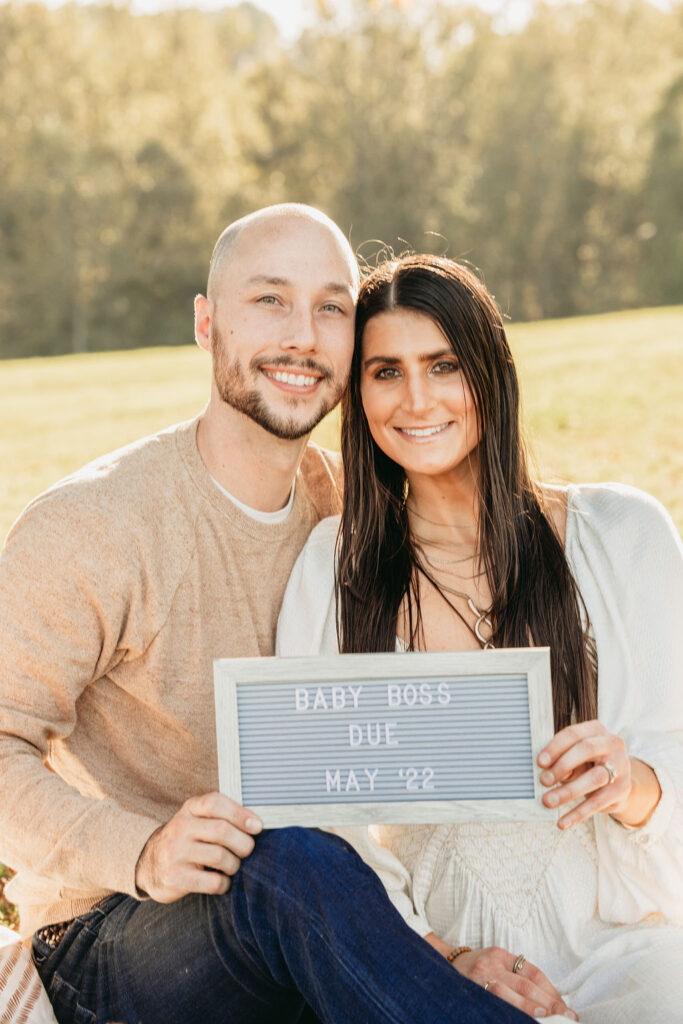 Caitlin and Kyle’s fall maternity session at a park in Flowery Branch, Georgia, featuring autumn foliage and a maternity picnic setup