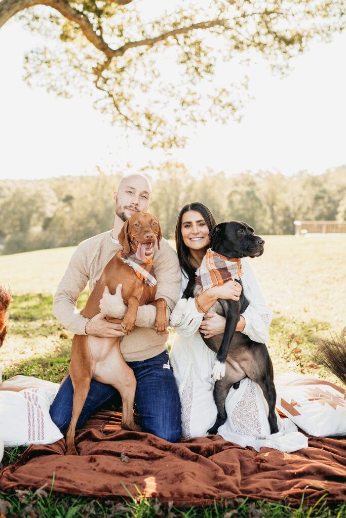 Caitlin and Kyle’s fall maternity session at a park in Flowery Branch, Georgia, featuring autumn foliage and a maternity picnic setup