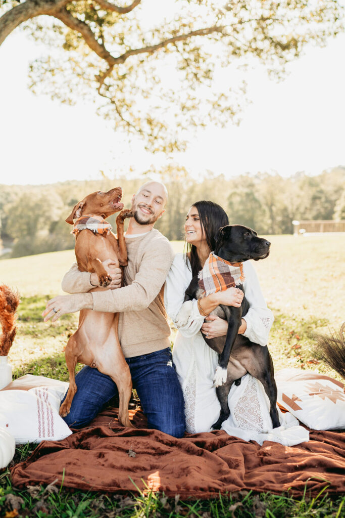 Caitlin and Kyle’s fall maternity session at a park in Flowery Branch, Georgia, featuring autumn foliage and a maternity picnic setup