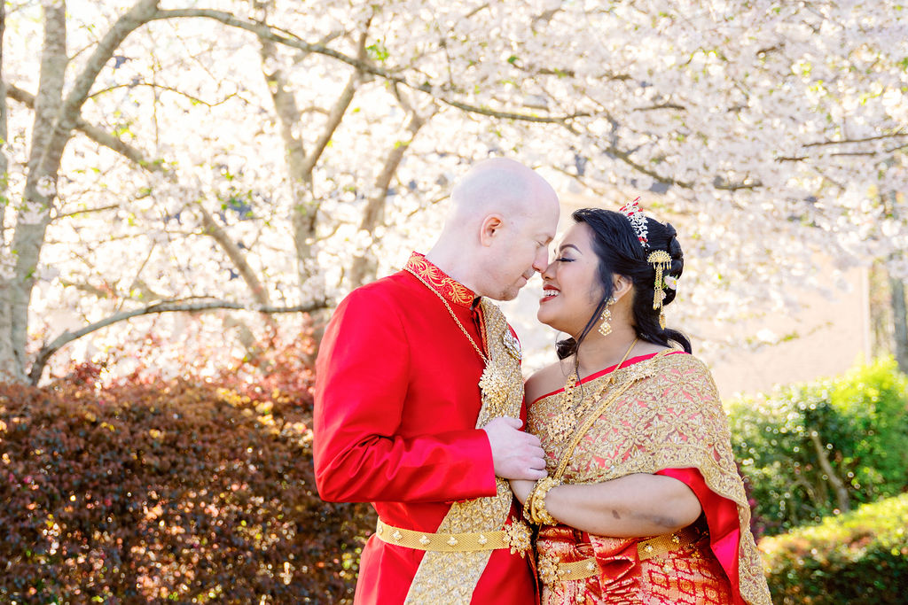 A beautiful Cambodian wedding in Atlanta featuring traditional gold attire and cherry blossom backdrops