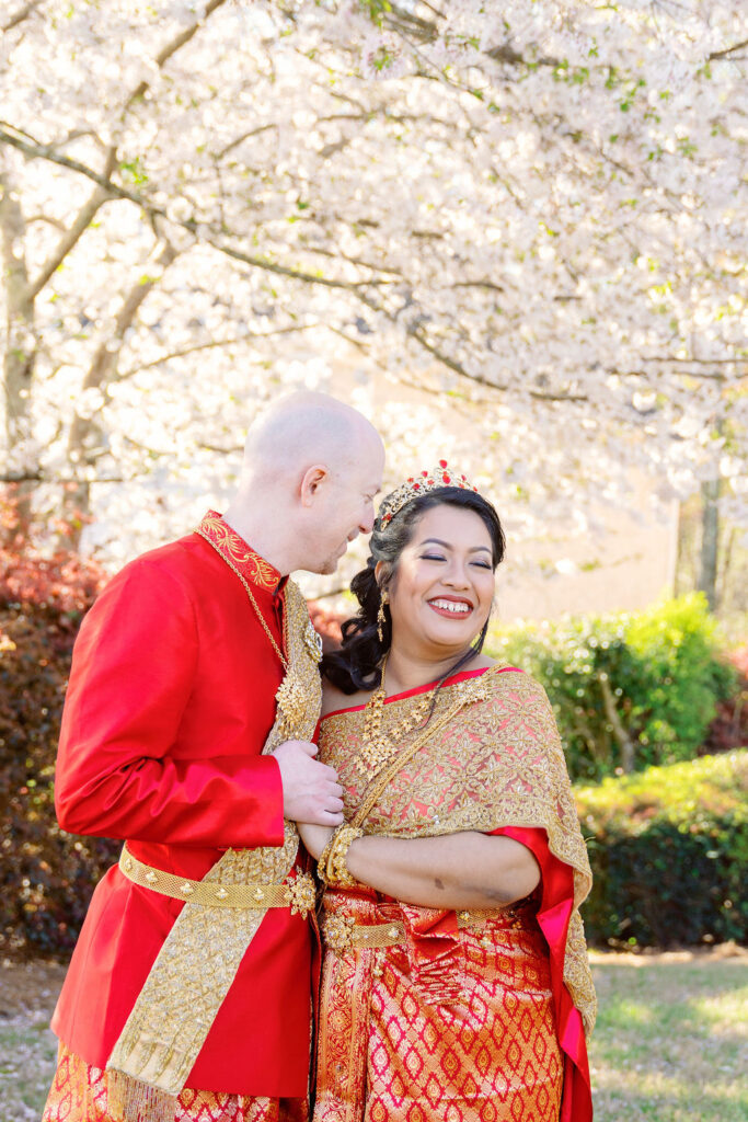 A beautiful Cambodian wedding in Atlanta featuring traditional gold attire and cherry blossom backdrops