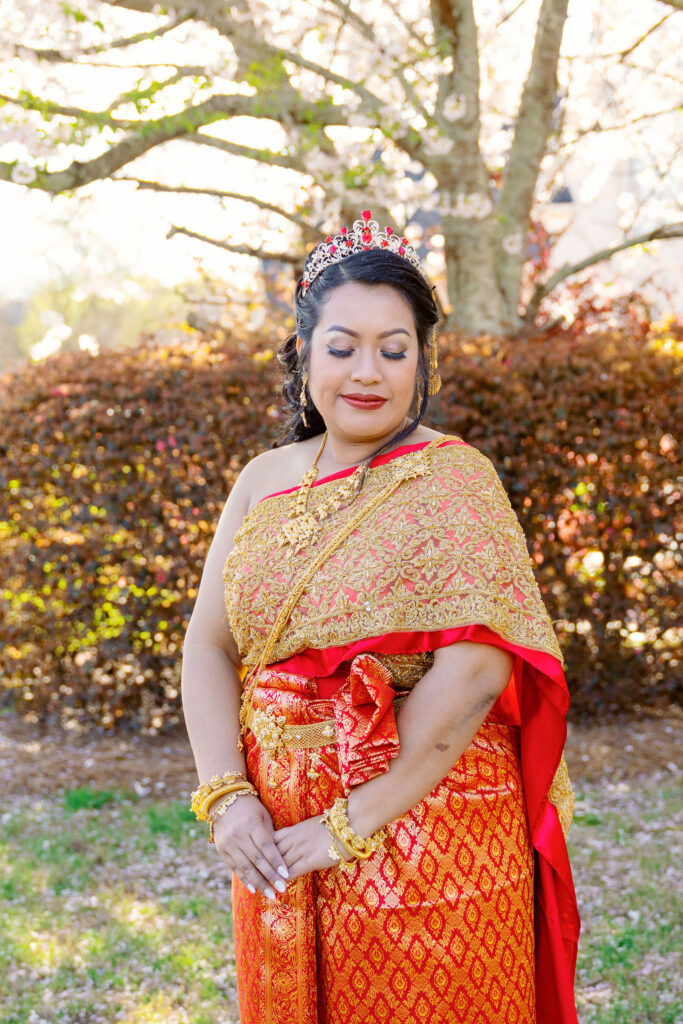 A beautiful Cambodian wedding in Atlanta featuring traditional gold attire and cherry blossom backdrops