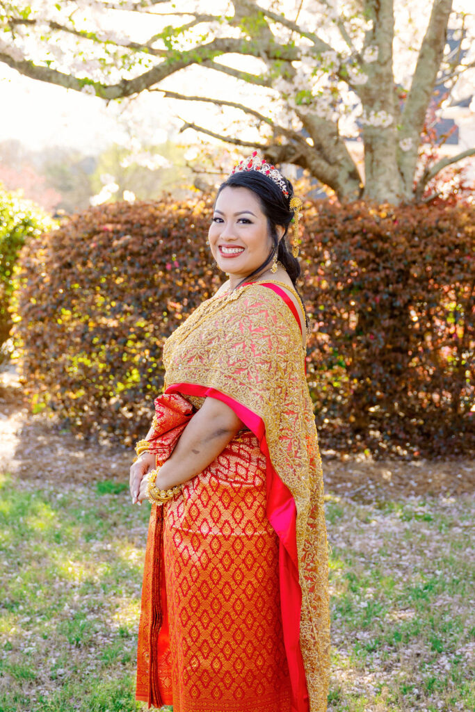 A beautiful Cambodian wedding in Atlanta featuring traditional gold attire and cherry blossom backdrops