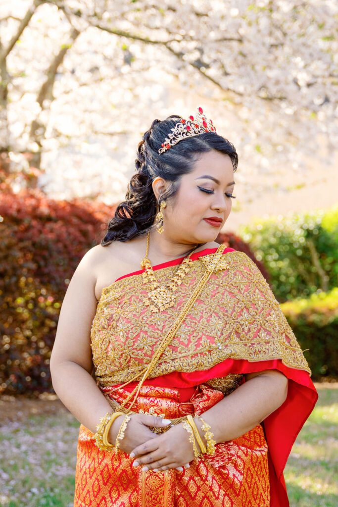 A beautiful Cambodian wedding in Atlanta featuring traditional gold attire and cherry blossom backdrops
