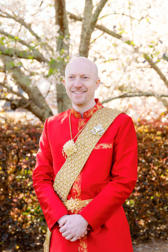 A beautiful Cambodian wedding in Atlanta featuring traditional gold attire and cherry blossom backdrops