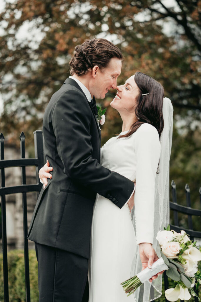 Romantic wedding at Rhodes Hall - bride and groom embracing on the staircase
