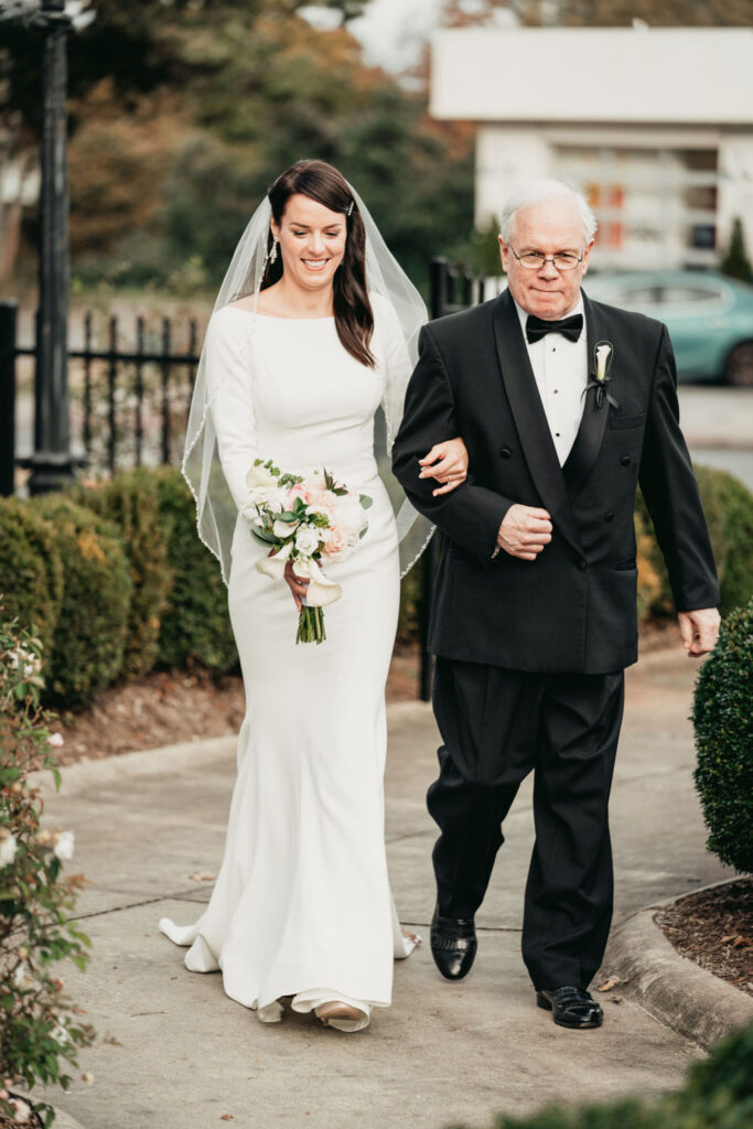 Romantic wedding at Rhodes Hall - bride and groom embracing on the staircase
