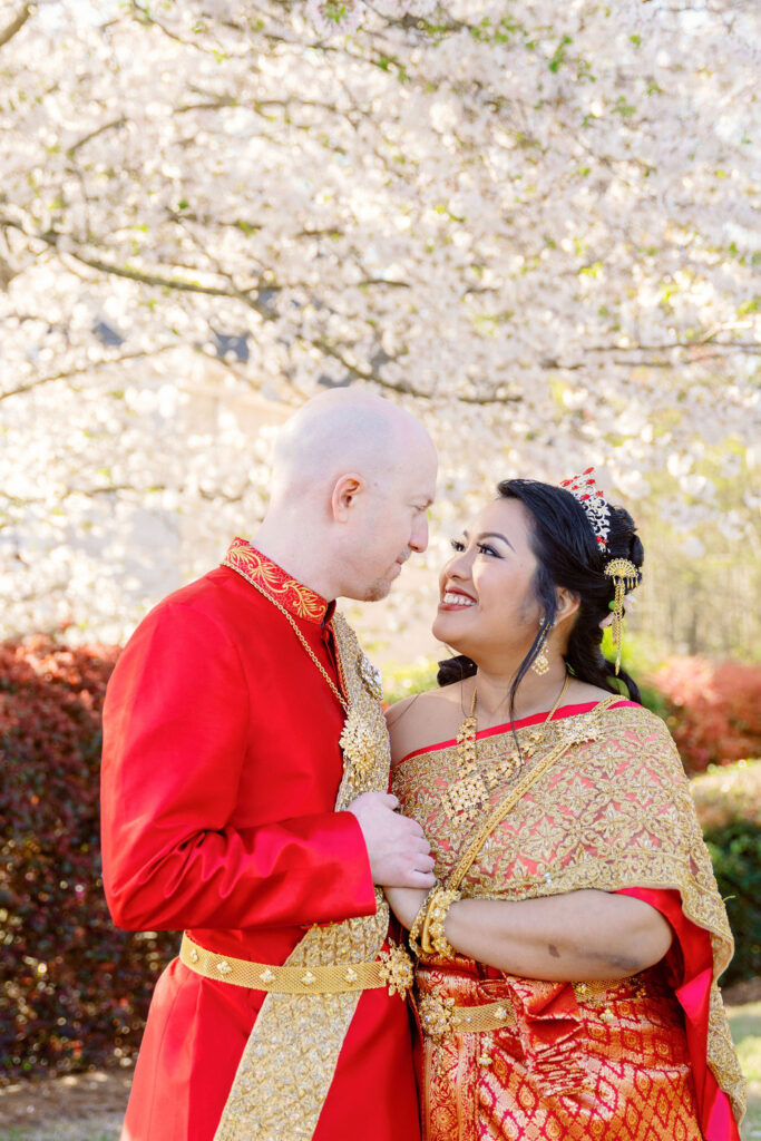 A beautiful Cambodian wedding in Atlanta featuring traditional gold attire and cherry blossom backdrops